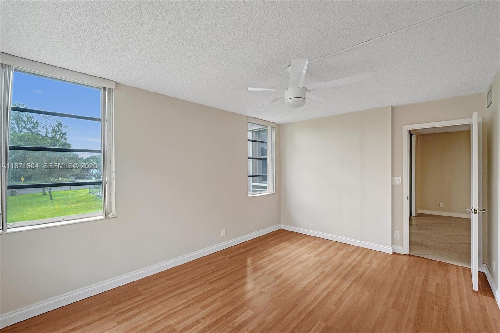 1900 Sabal Palm Drive, Unit 201 Davie, FL 33324 - Photo 20 of 23 a view of an empty room with wooden floor and a window