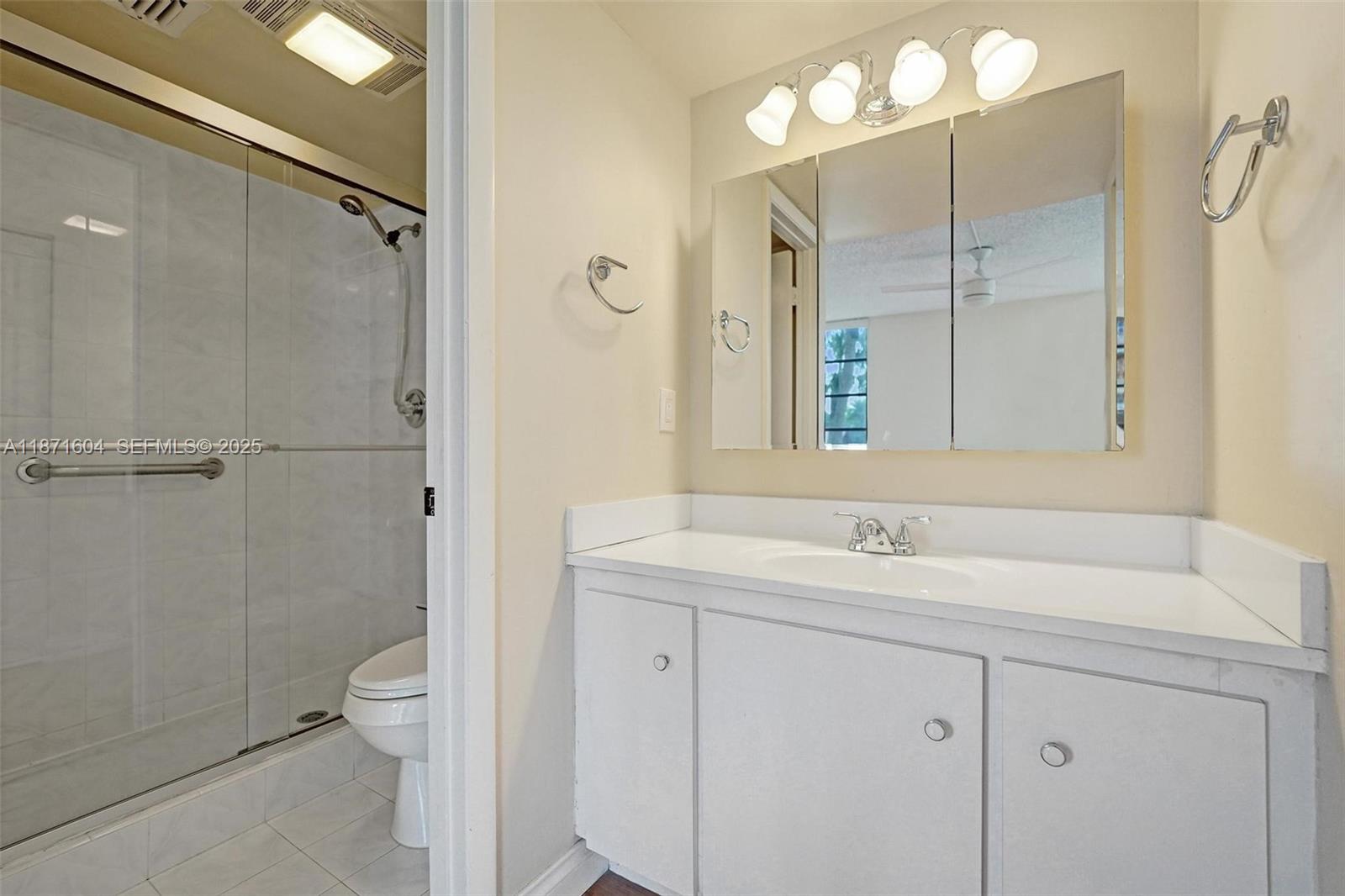 1900 Sabal Palm Drive, Unit 201 Davie, FL 33324 - Photo 21 of 23 a bathroom with a sink a toilet and shower