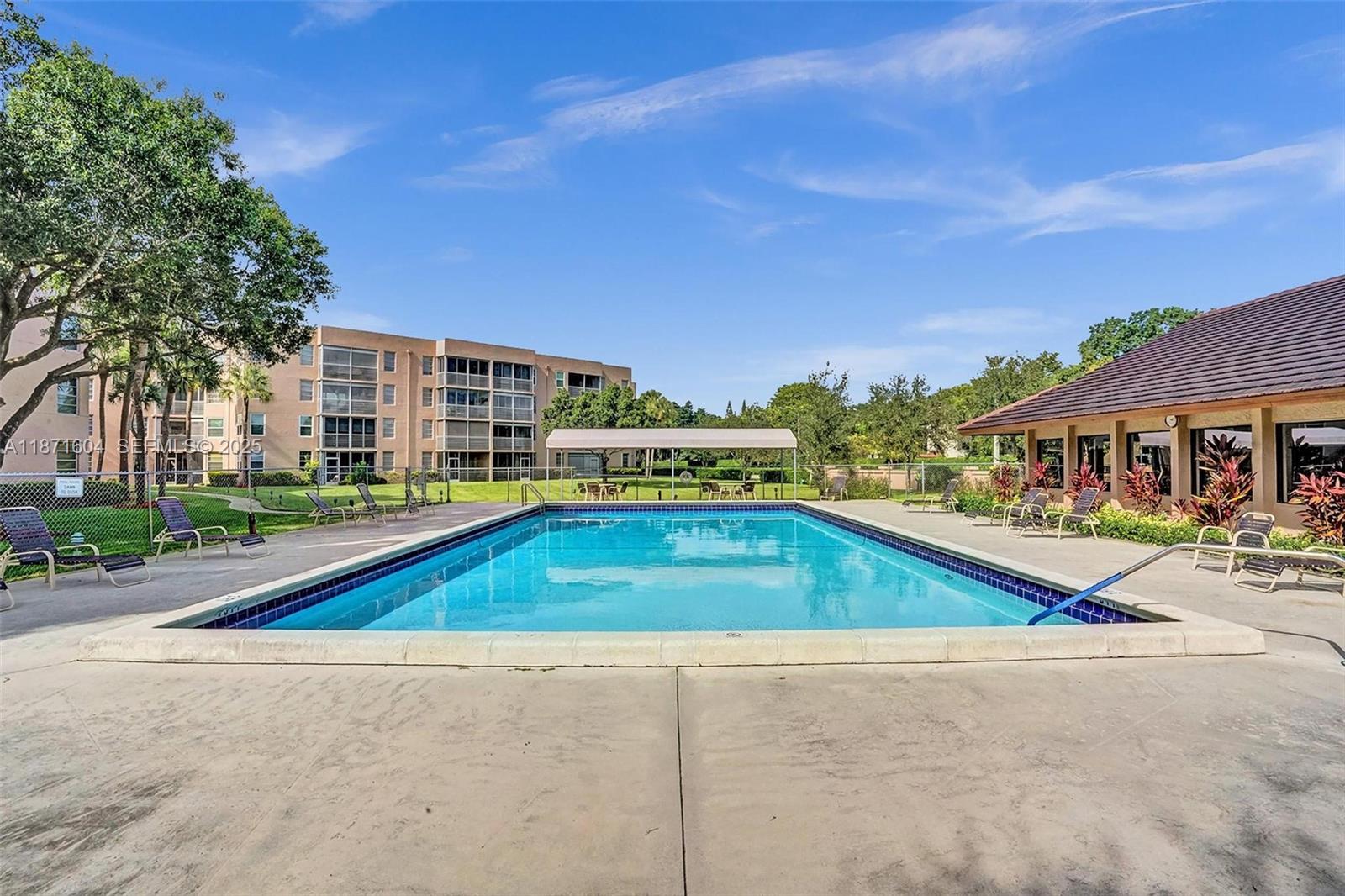 1900 Sabal Palm Drive, Unit 201 Davie, FL 33324 - Photo 23 of 23 a view of pool with outdoor seating and house in the background