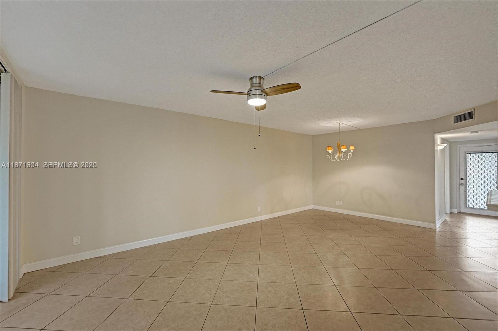 1900 Sabal Palm Drive, Unit 201 Davie, FL 33324 - Photo 7 of 23 an empty room with a ceiling fan and carpet