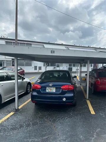 a view of a house with backyard and porch