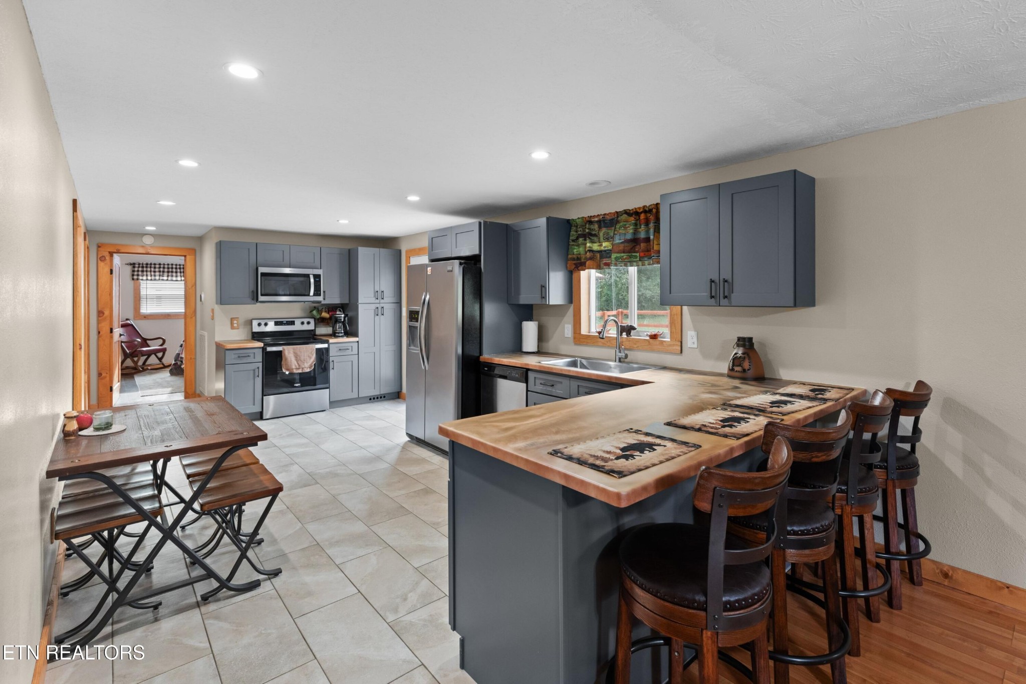 2811 Eugene Road Newport, TN 37821 - Photo 8 of 33 a kitchen with stainless steel appliances granite countertop a table chairs refrigerator and sink