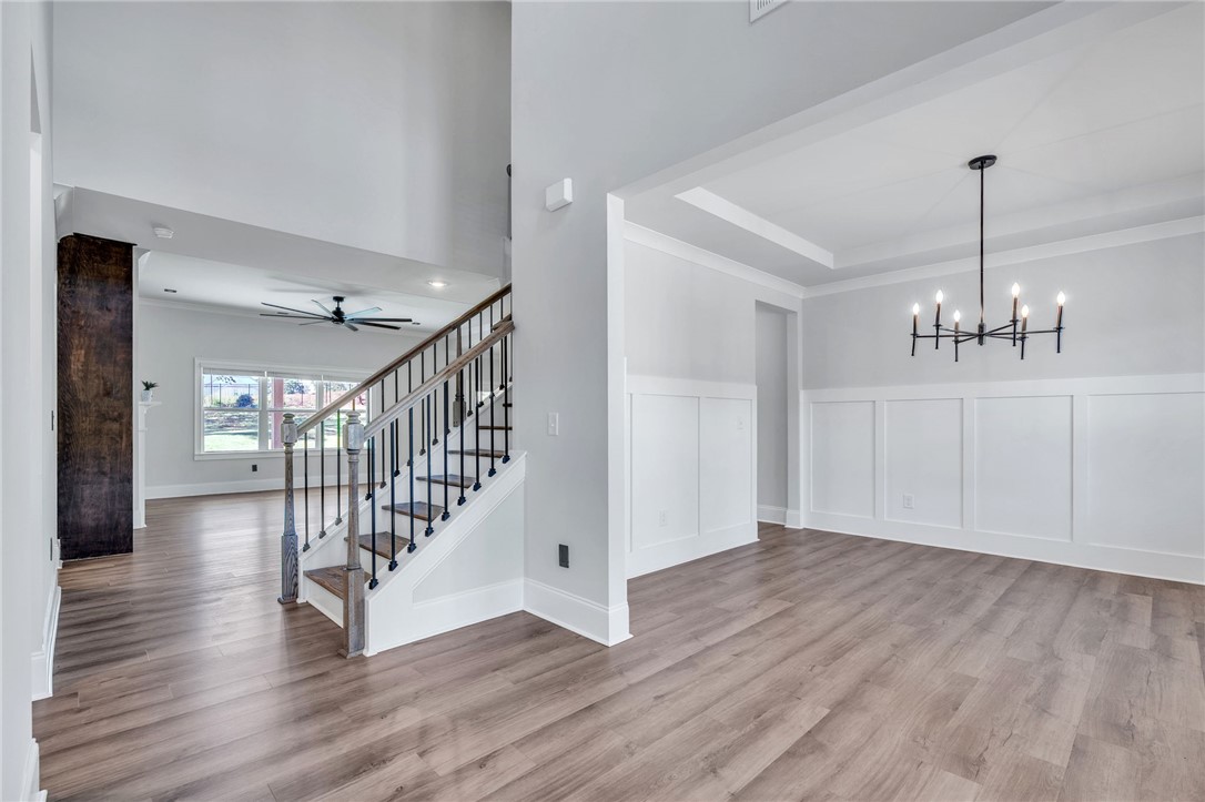 226 Holly Br Road Piedmont, SC 29673 - Photo 12 of 44 An inviting entry foyer reveals a formal dining space adorned with wainscoting and an elegant chandelier.