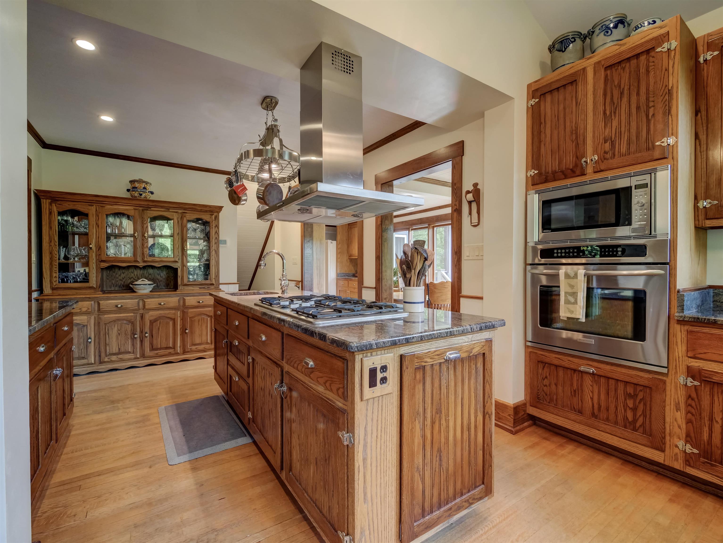 7304 Dry Run Road Williamsville, VA 24487 - Photo 23 of 57 a kitchen with stainless steel appliances granite countertop a stove top oven a sink dishwasher a dining table and chairs with wooden floor