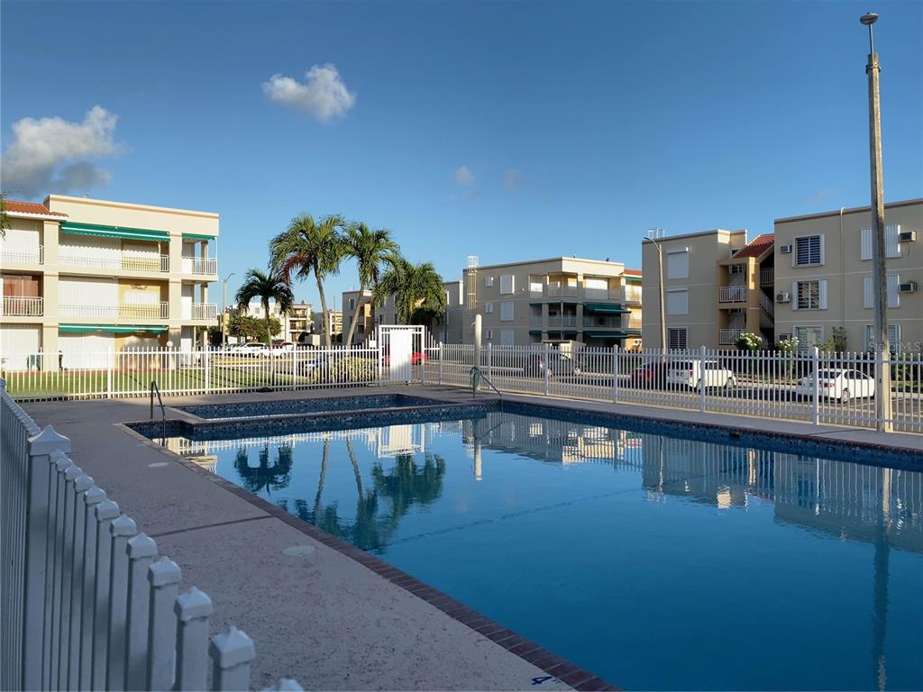 968 Camino Las Picüas, Unit 30 Rio Grande, Río Grande 00745 - Photo 2 of 24 a view of a swimming pool and outdoor seating