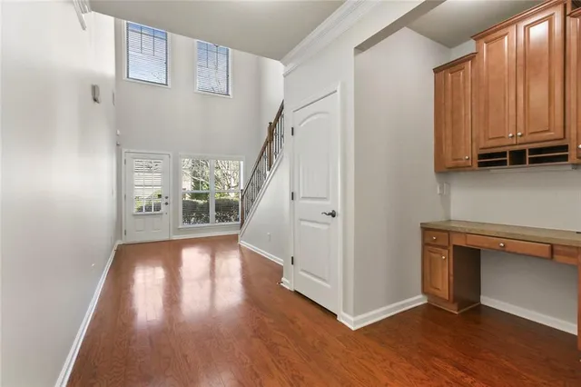 a view of hallway with stairs and wooden floor