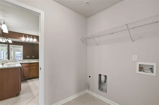 a view of a storage & utility room with a sink