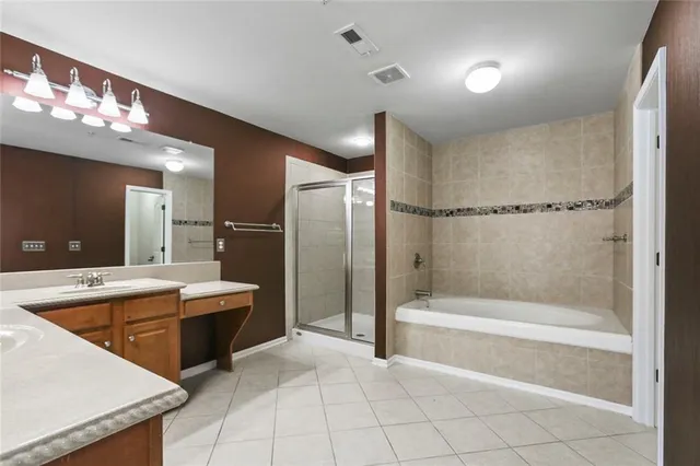 a spacious bathroom with a tub a shower and sink