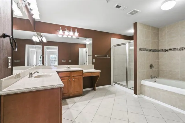 a spacious bathroom with a bathtub sink and a mirror