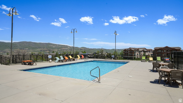 1364 Still Water Drive, Unit R2012 Heber City, UT 84032 - Photo 27 of 30 Outdoor swimming pool with integrated steps and a metal handrail, surrounded by a concrete deck