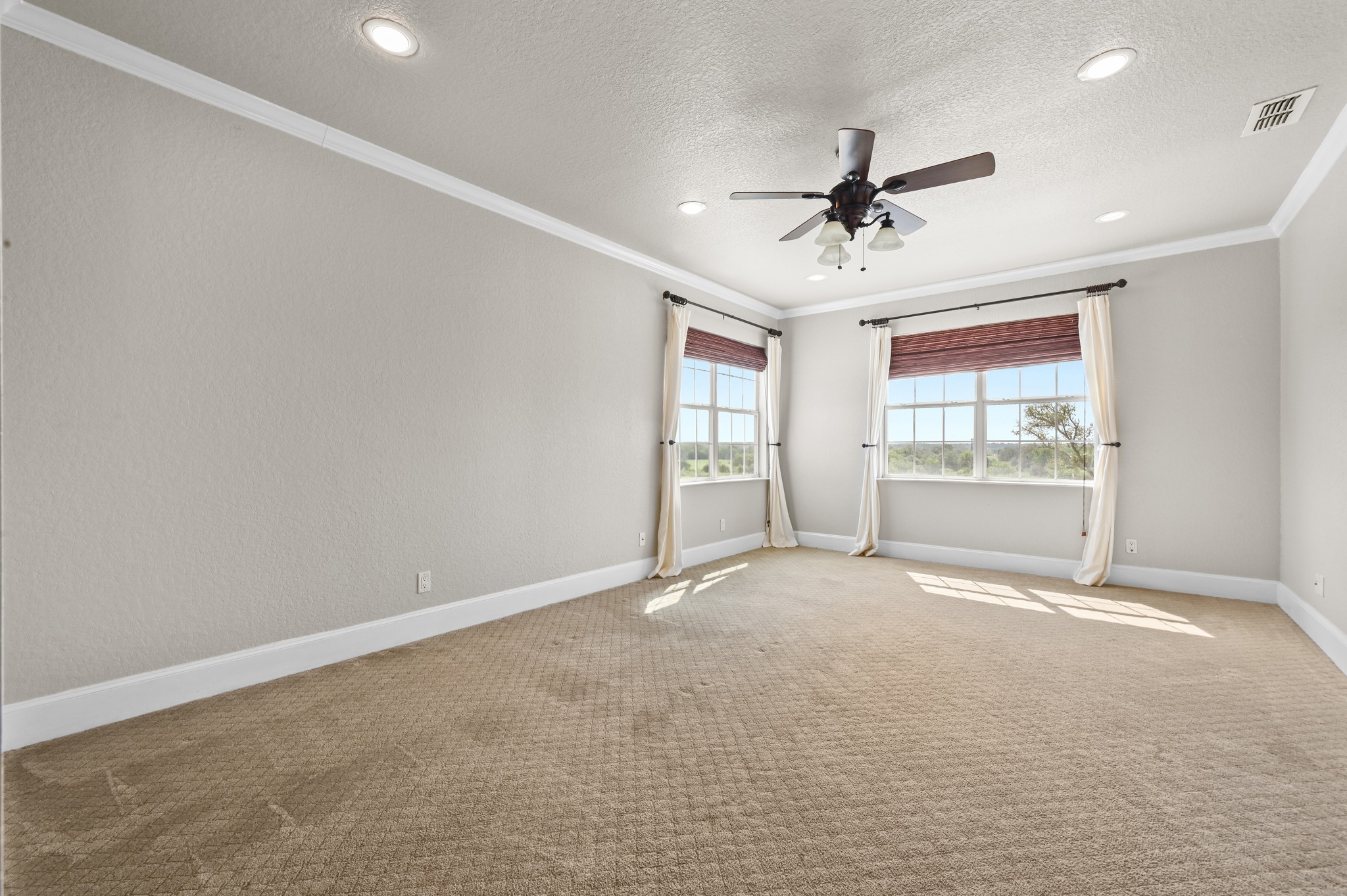 1175 Southern Way Luling, TX 78648 - Photo 26 of 40 Sun-filled primary bedroom with plush carpeting, recessed lighting, and a ceiling fan.