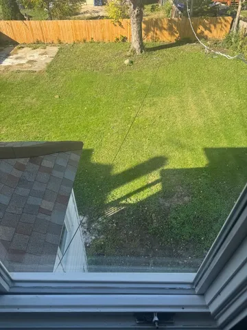 a view of a floor to ceiling window and an outdoor space