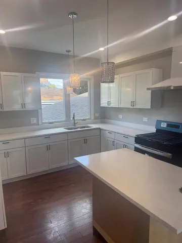 a kitchen with a sink a window and stainless steel appliances