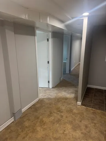 an empty room with an entrance to other room