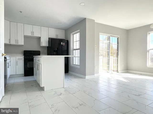 a kitchen with a stove a refrigerator and a cabinets