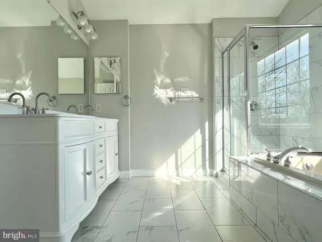 a bathroom with a sink a granite counter and a mirror