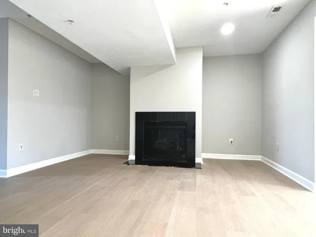 a view of an empty room with cabinet and cabinet