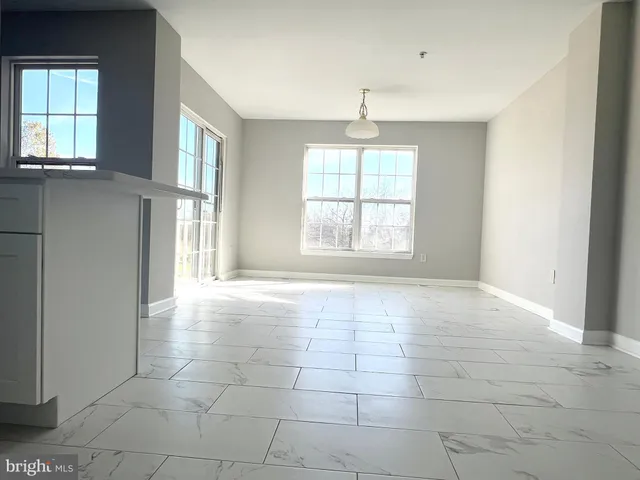 an empty room with a empty space and windows