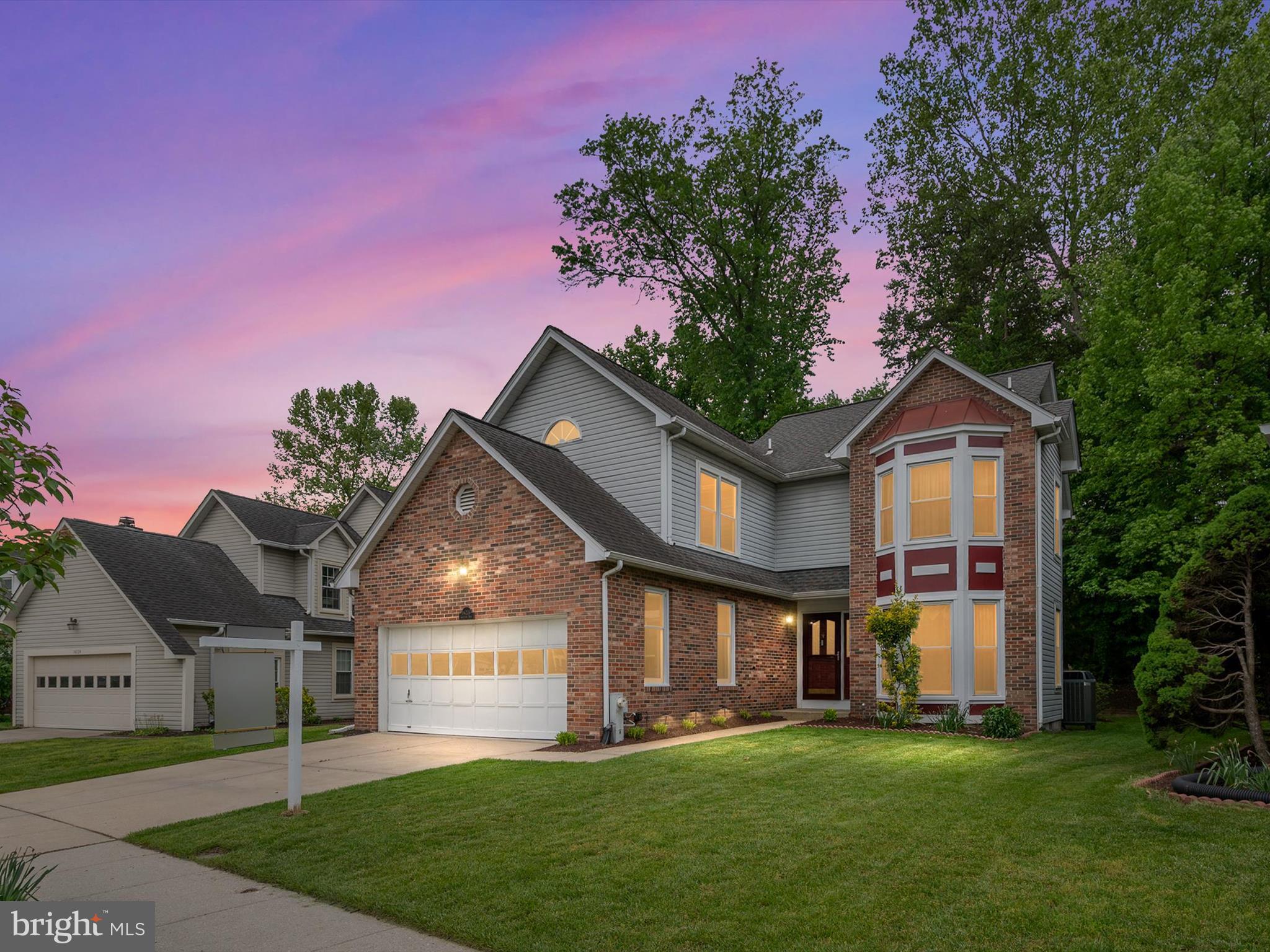 a front view of a house with a garden and plants