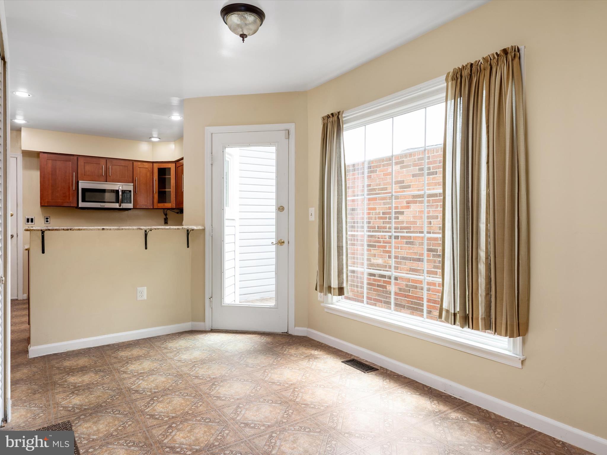 14226 Greenview Drive Laurel, MD 20708 - Photo 17 of 46 a view of a kitchen with a stove cabinets and a window