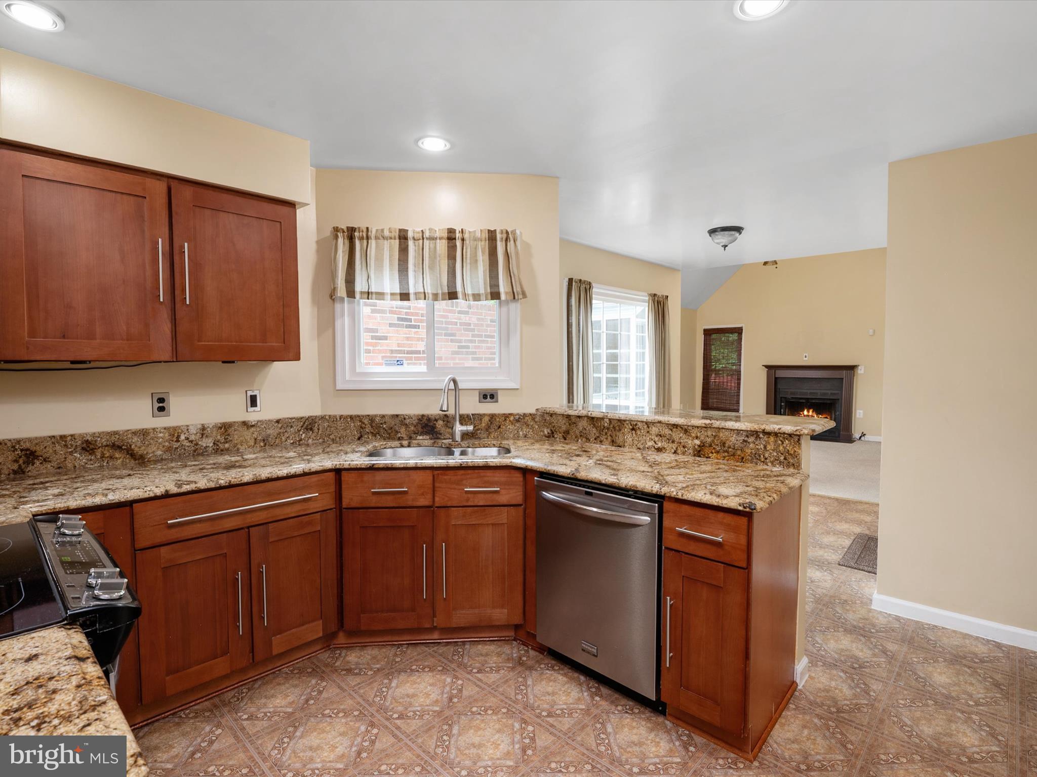 14226 Greenview Drive Laurel, MD 20708 - Photo 21 of 46 a kitchen with granite countertop stainless steel appliances stove sink and cabinets