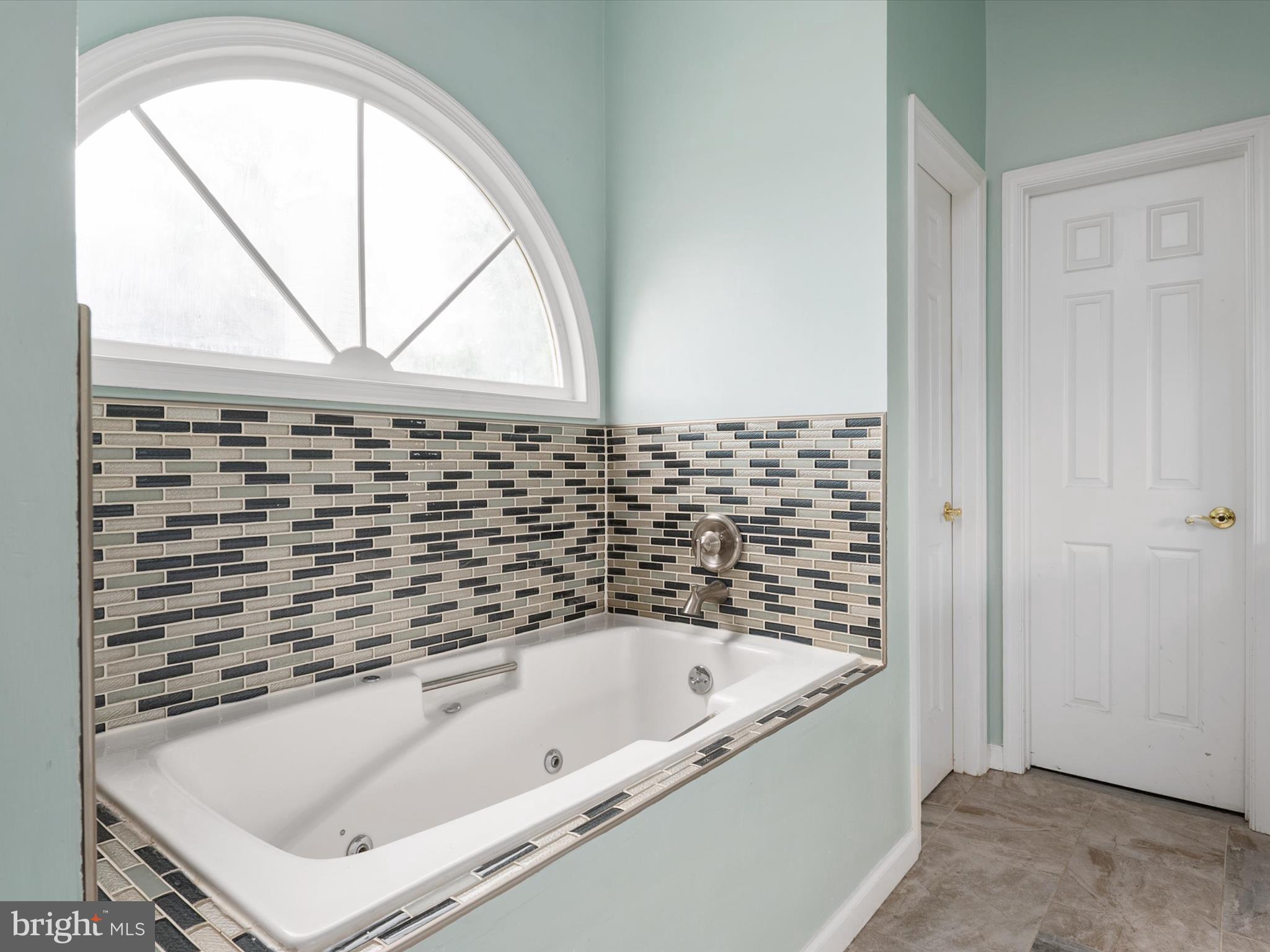 14226 Greenview Drive Laurel, MD 20708 - Photo 37 of 46 a bathroom with a bathtub and a window