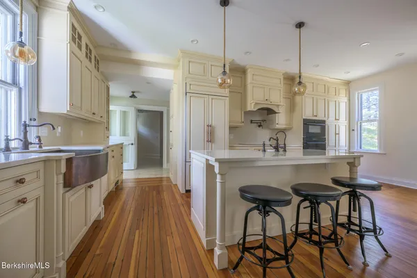 a kitchen with stainless steel appliances white cabinets and a stove