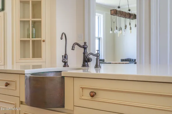 a open kitchen with cabinets and wooden floor