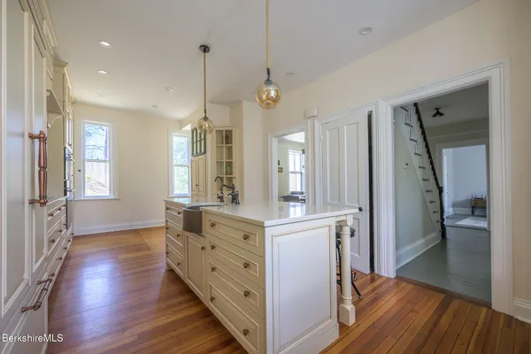 a spacious bedroom with a bed and a chandelier