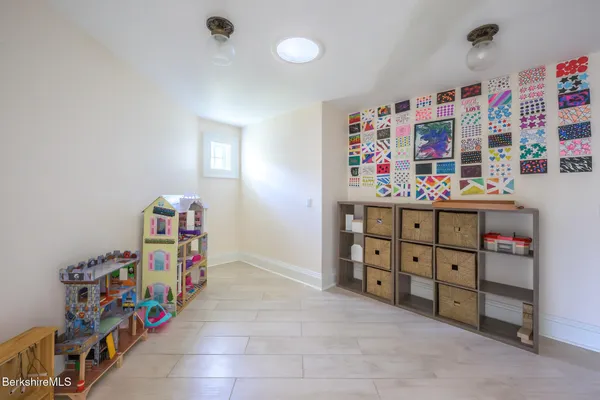 a bedroom with a bed a window and walk in closet