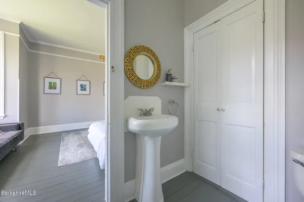 a bathroom with a granite countertop sink a mirror and shower
