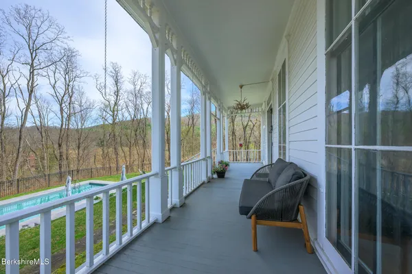 a view of a porch with furniture and a gate