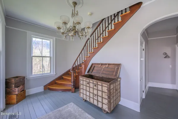 a view of entryway with wooden floor and stairs
