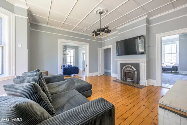 a living room with furniture a fireplace and a flat screen tv