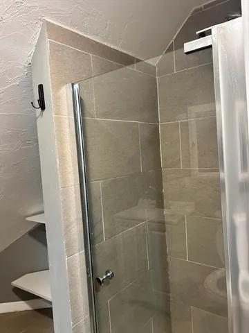 a bathroom with a shower and a mirror