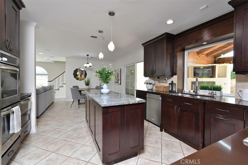 3935 Bon Homme Road Calabasas, CA 91302 - Photo 23 of 64 a kitchen with kitchen island granite countertop a sink counter top space appliances and a window
