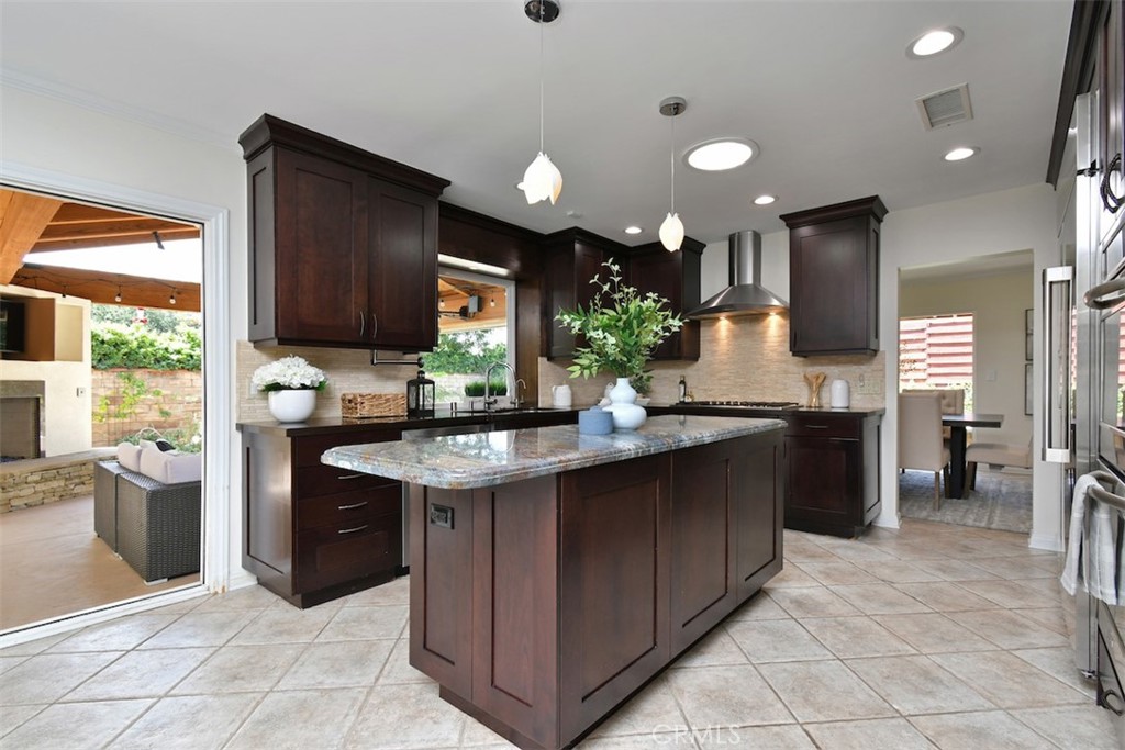 3935 Bon Homme Road Calabasas, CA 91302 - Photo 25 of 64 a kitchen with stainless steel appliances granite countertop a sink counter space cabinets and a large window