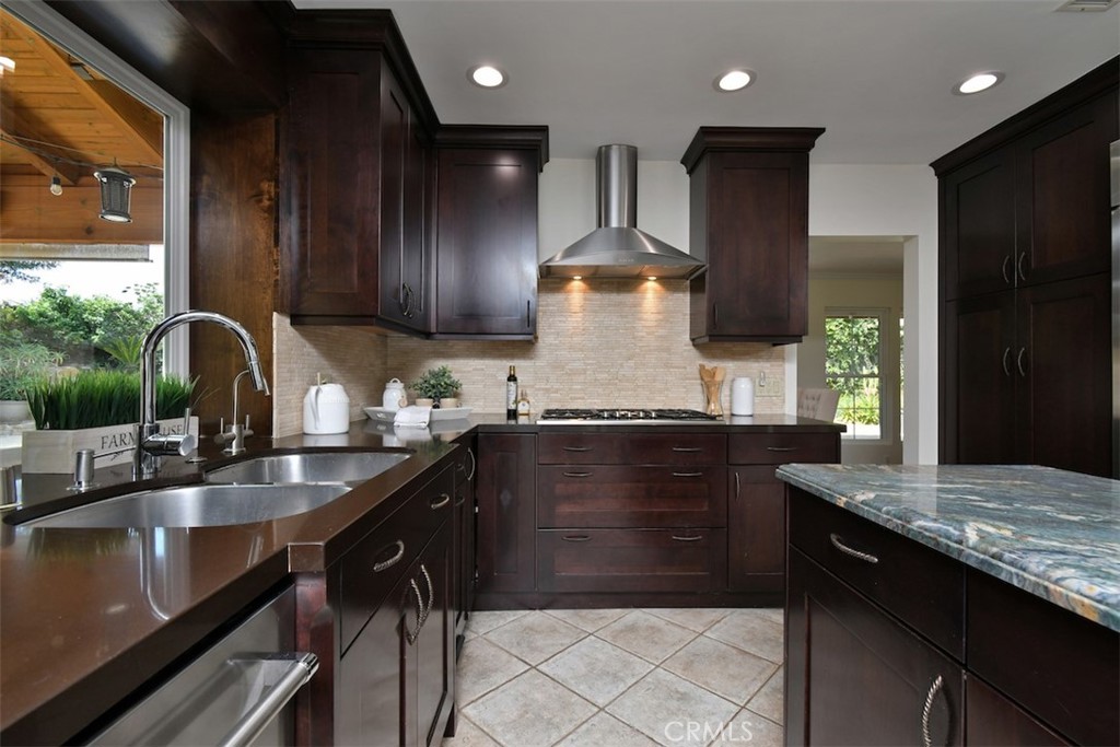 3935 Bon Homme Road Calabasas, CA 91302 - Photo 26 of 64 a kitchen with granite countertop a sink stove and cabinets