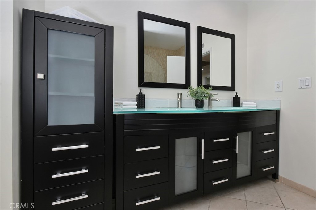 3935 Bon Homme Road Calabasas, CA 91302 - Photo 32 of 64 a bathroom with a double vanity sink and mirror