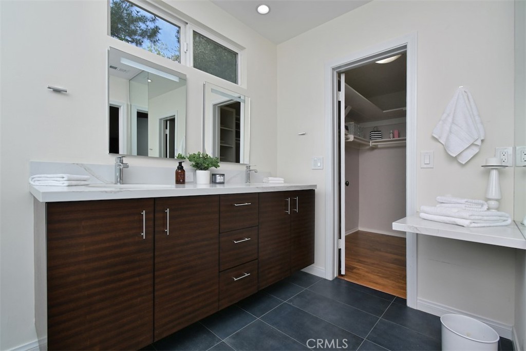 3935 Bon Homme Road Calabasas, CA 91302 - Photo 38 of 64 a bathroom with a double vanity sink and a mirror