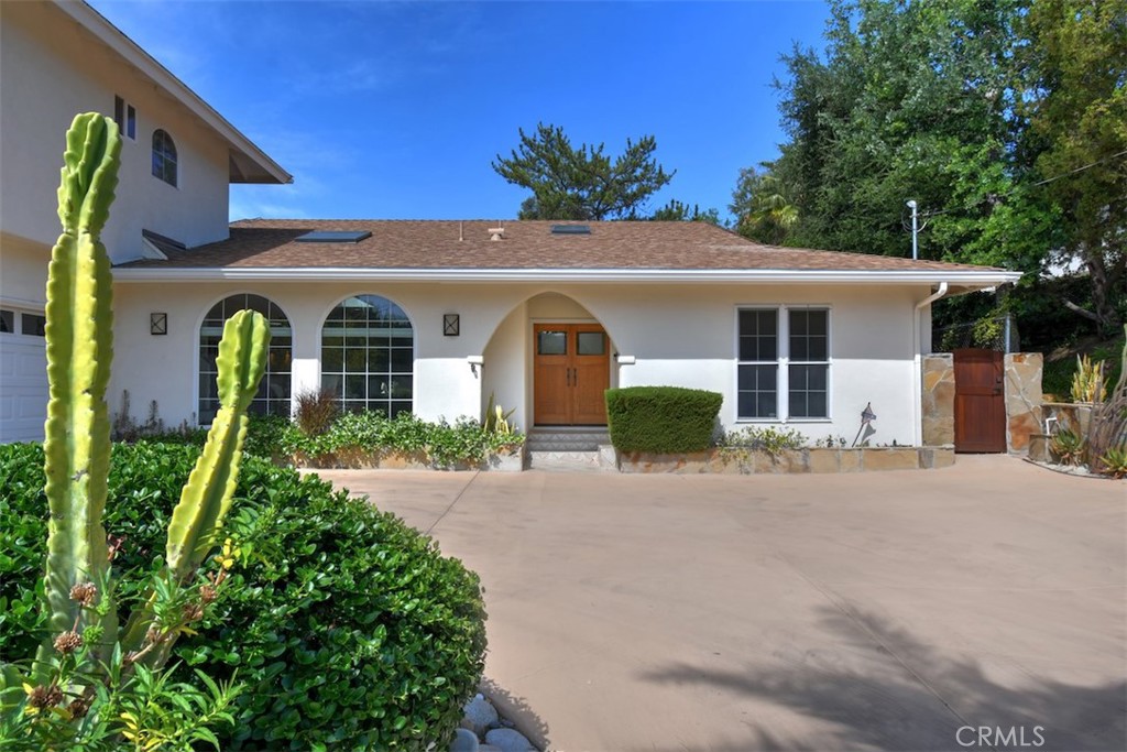 3935 Bon Homme Road Calabasas, CA 91302 - Photo 5 of 64 a front view of a house with a yard and garage