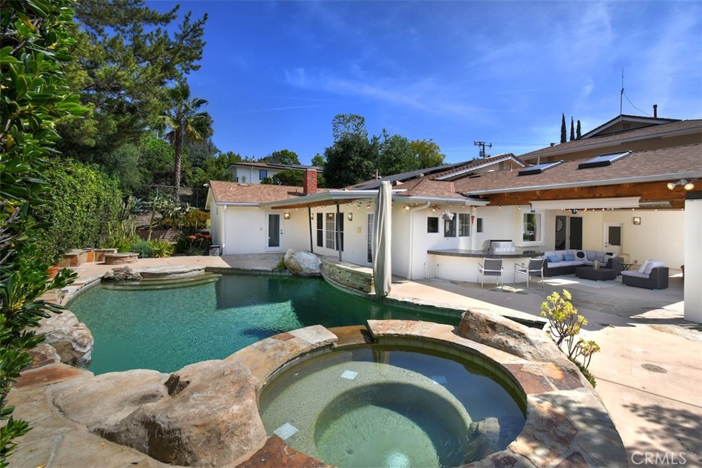 3935 Bon Homme Road Calabasas, CA 91302 - Photo 58 of 64 a view of a house with pool and chairs