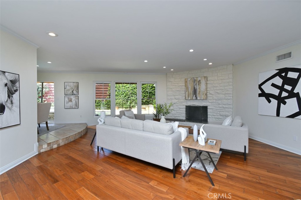 3935 Bon Homme Road Calabasas, CA 91302 - Photo 9 of 64 a living room with furniture a fireplace and a floor to ceiling window
