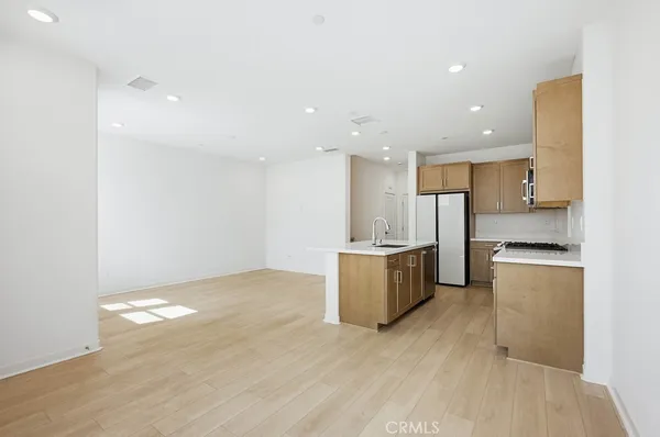 a large kitchen with stainless steel appliances kitchen island granite countertop a sink and cabinets