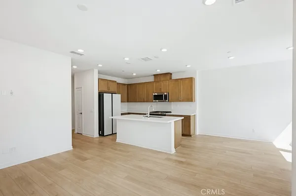 a kitchen with stainless steel appliances granite countertop a sink a stove and a refrigerator