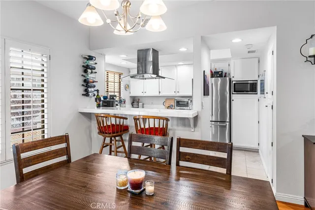 a dining room with furniture a chandelier and wooden floor