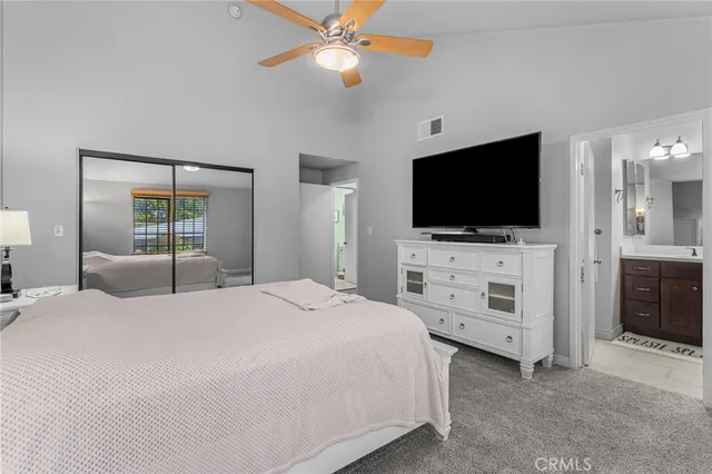 a bedroom with a bed tv and a window