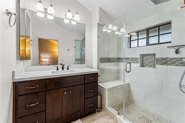 a bathroom with a sink vanity granite and a mirror