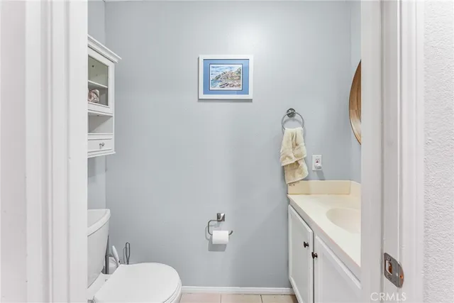 a bathroom with a toilet a sink and a mirror