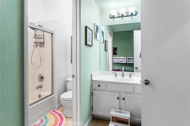 a bathroom with a glass shower door